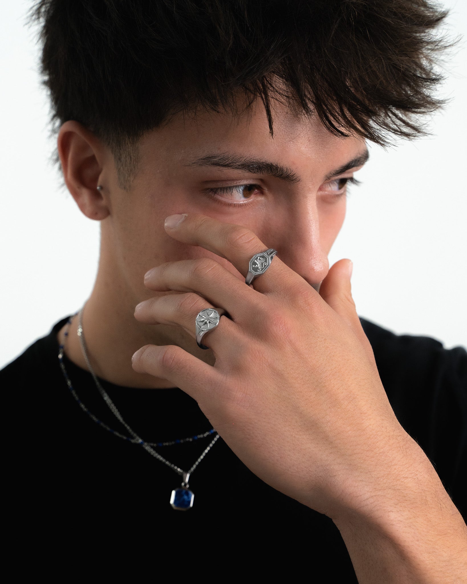 Close up of a man wearing a STAR SILVER RING with a bold star motif on the finger