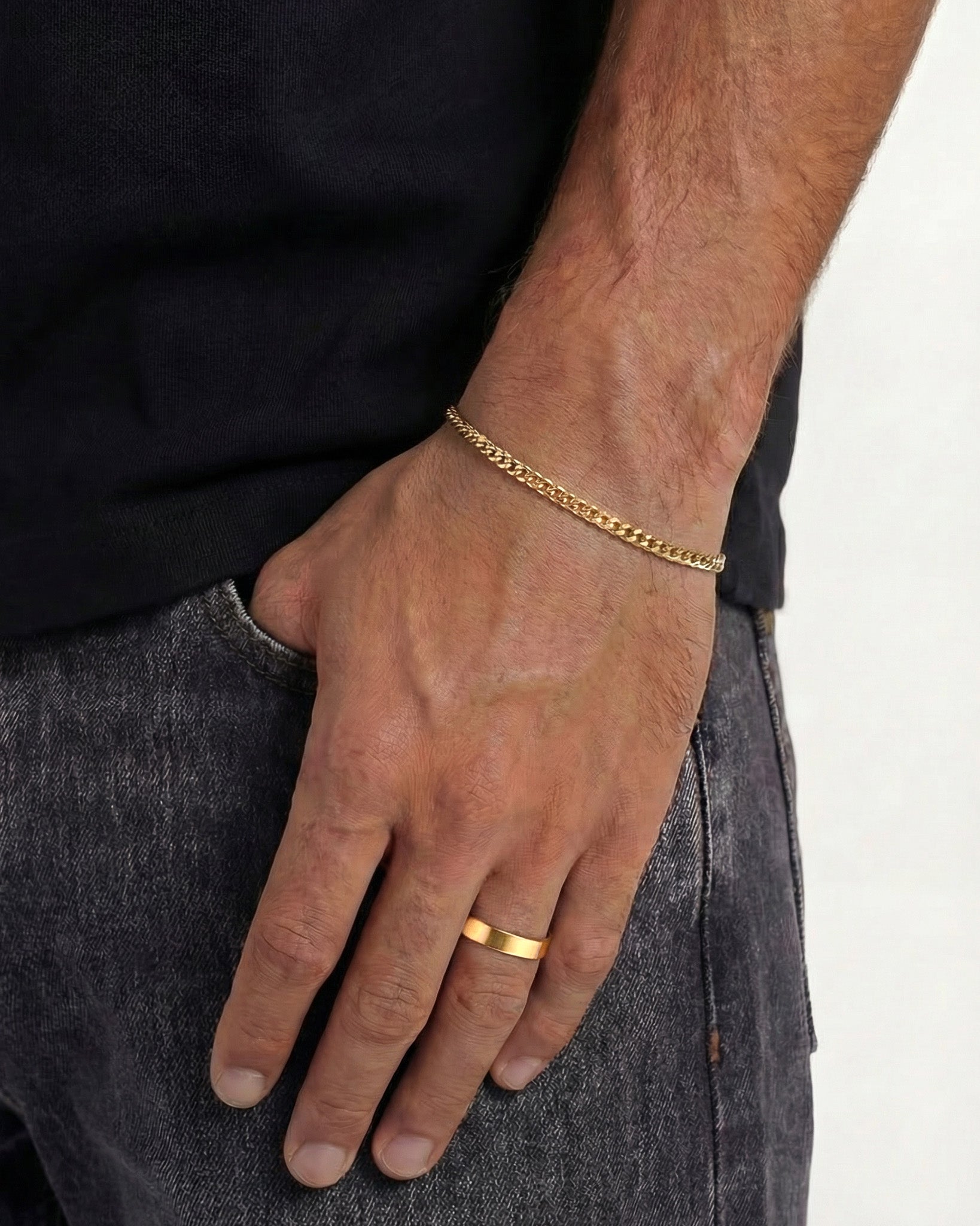 Gold KUBU bracelet worn on a man's wrist with an adjustable clasp
