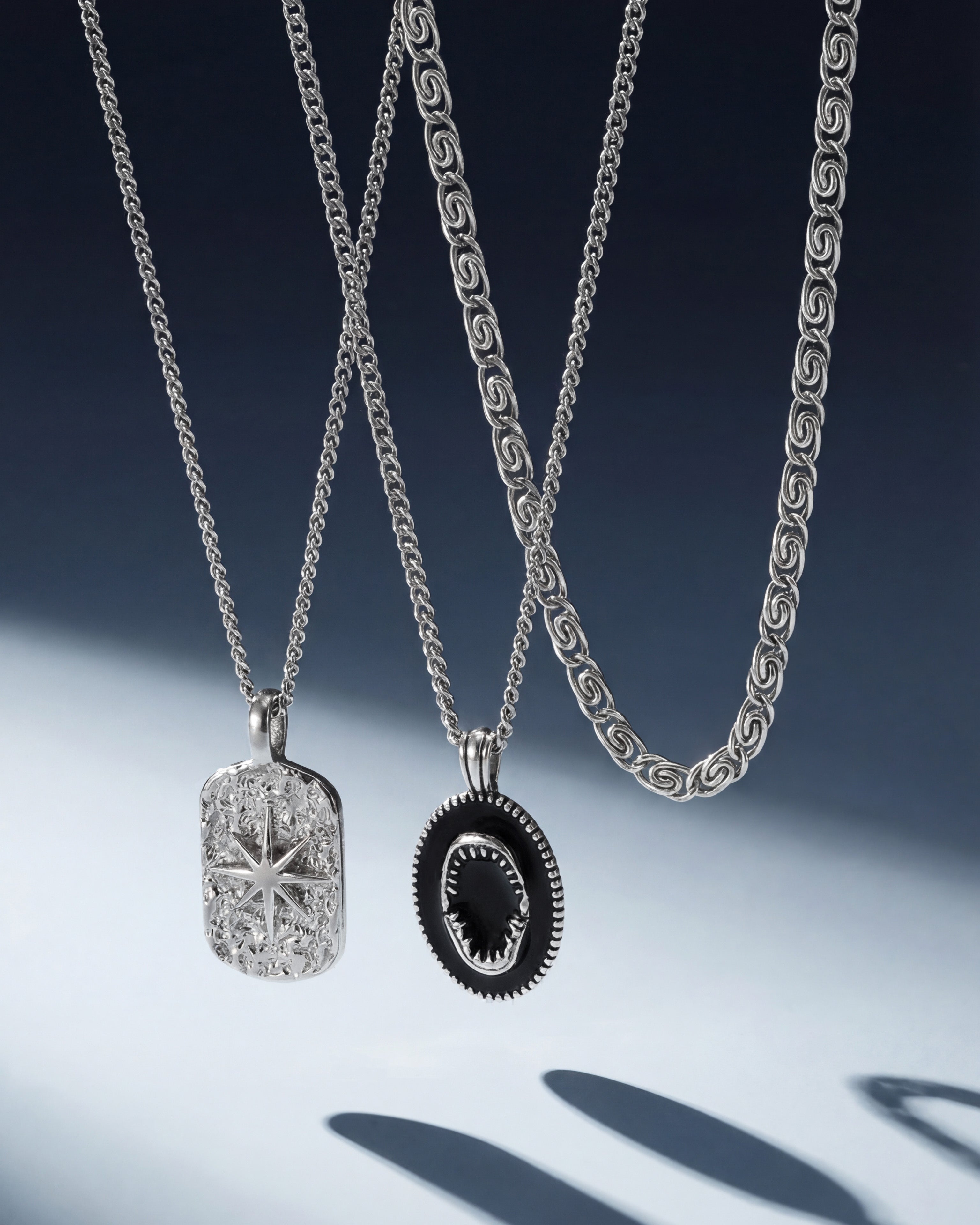 Silver IBZ necklace with two pendants a textured rectangular medallion and a circular black bordered pendant on a 50 cm chain with adjustable length