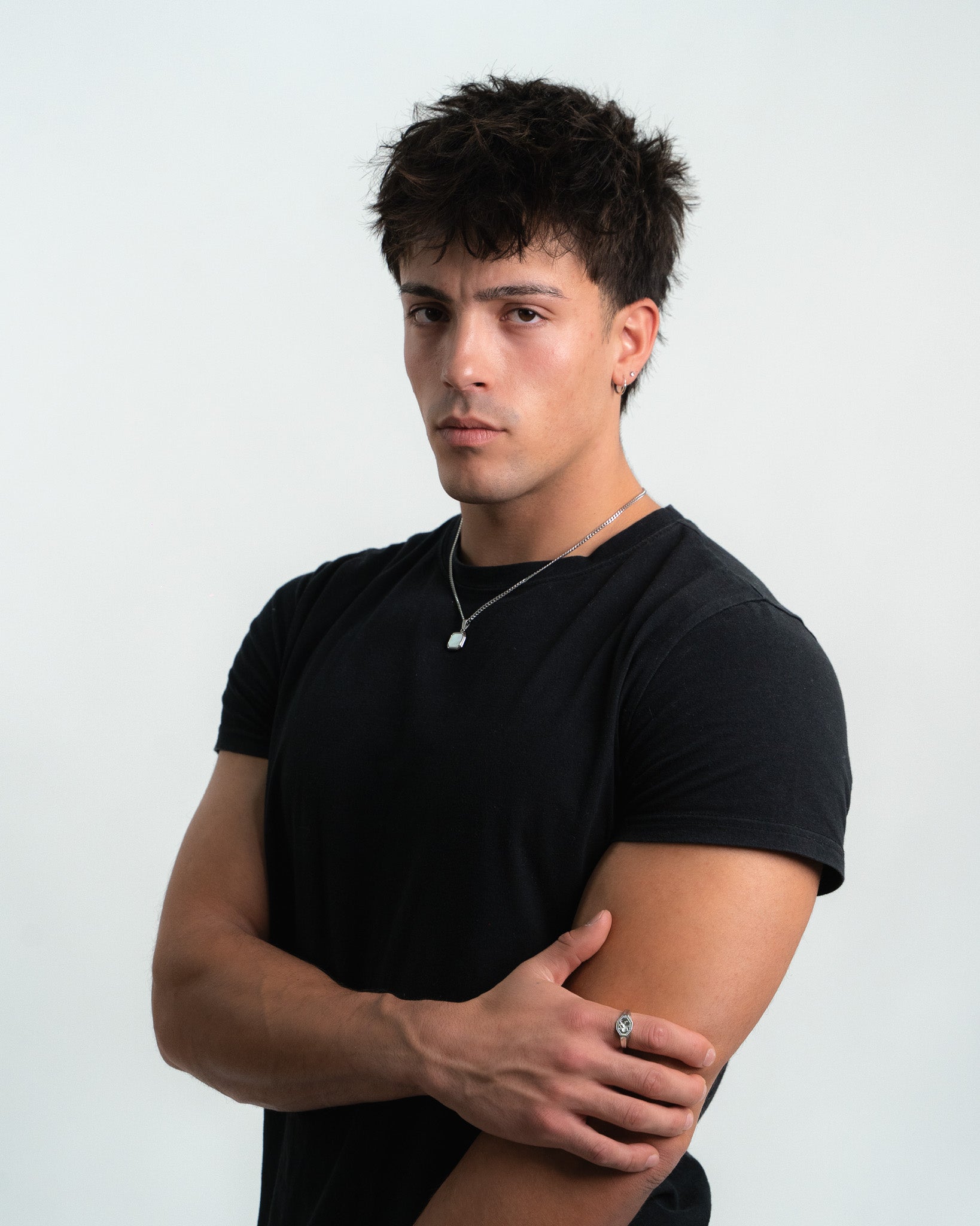 Close up of a person wearing the NOVA Silver Necklace with two layered chains and a pendant at the chest