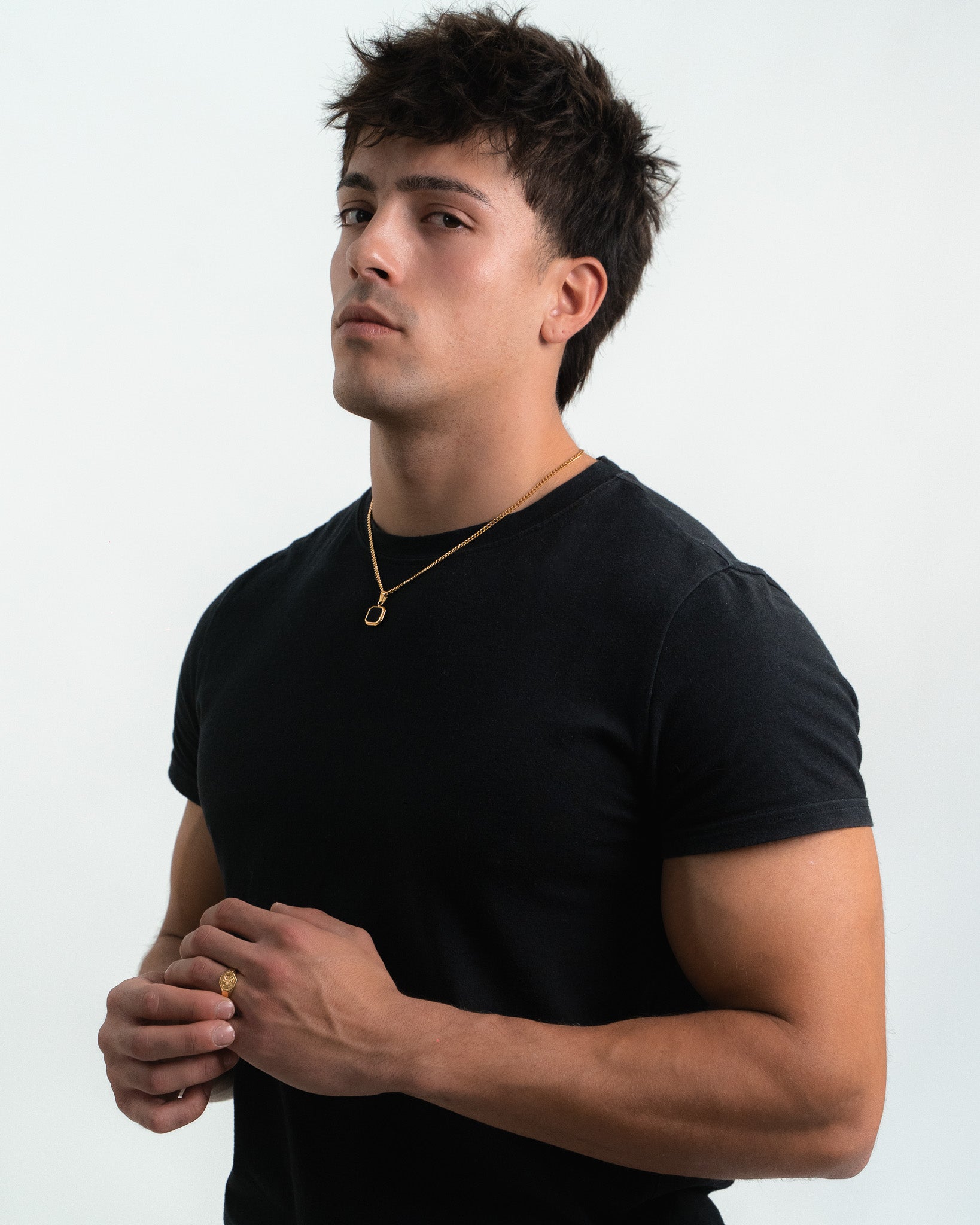 Model wearing Nova Gold necklace with a double chain design and a pendant at the chest