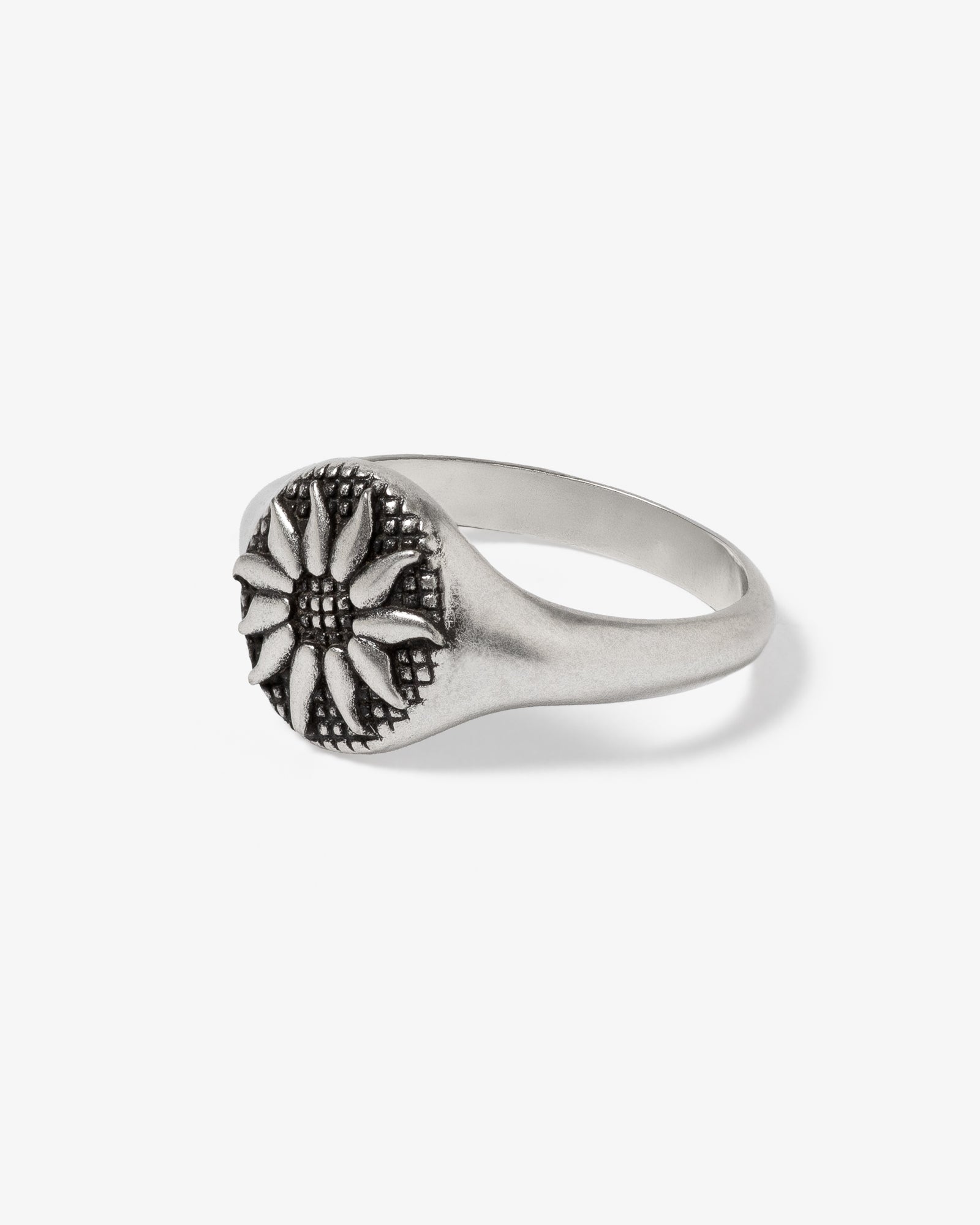 Fleur Silver Ring close up showing a flower motif on a smooth silver band