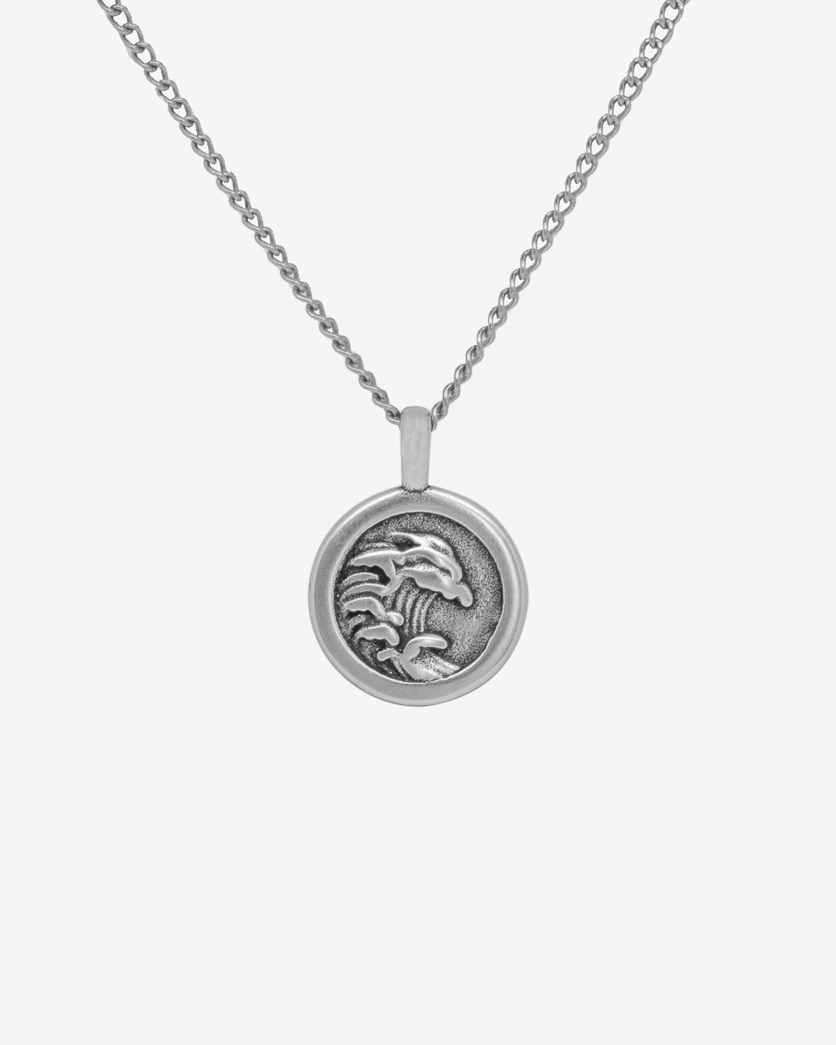 Silver chain necklace with a round engraved pendant featuring a detailed design.