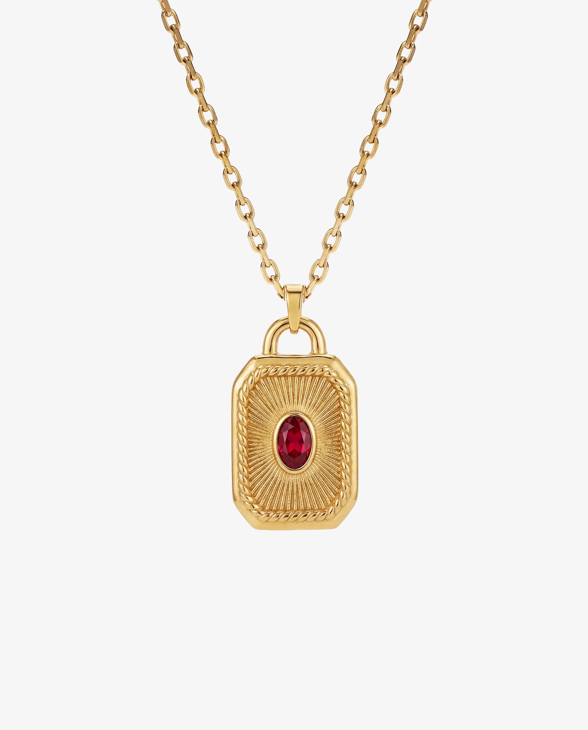 Gold chain necklace with an ornate pendant set with a red gemstone