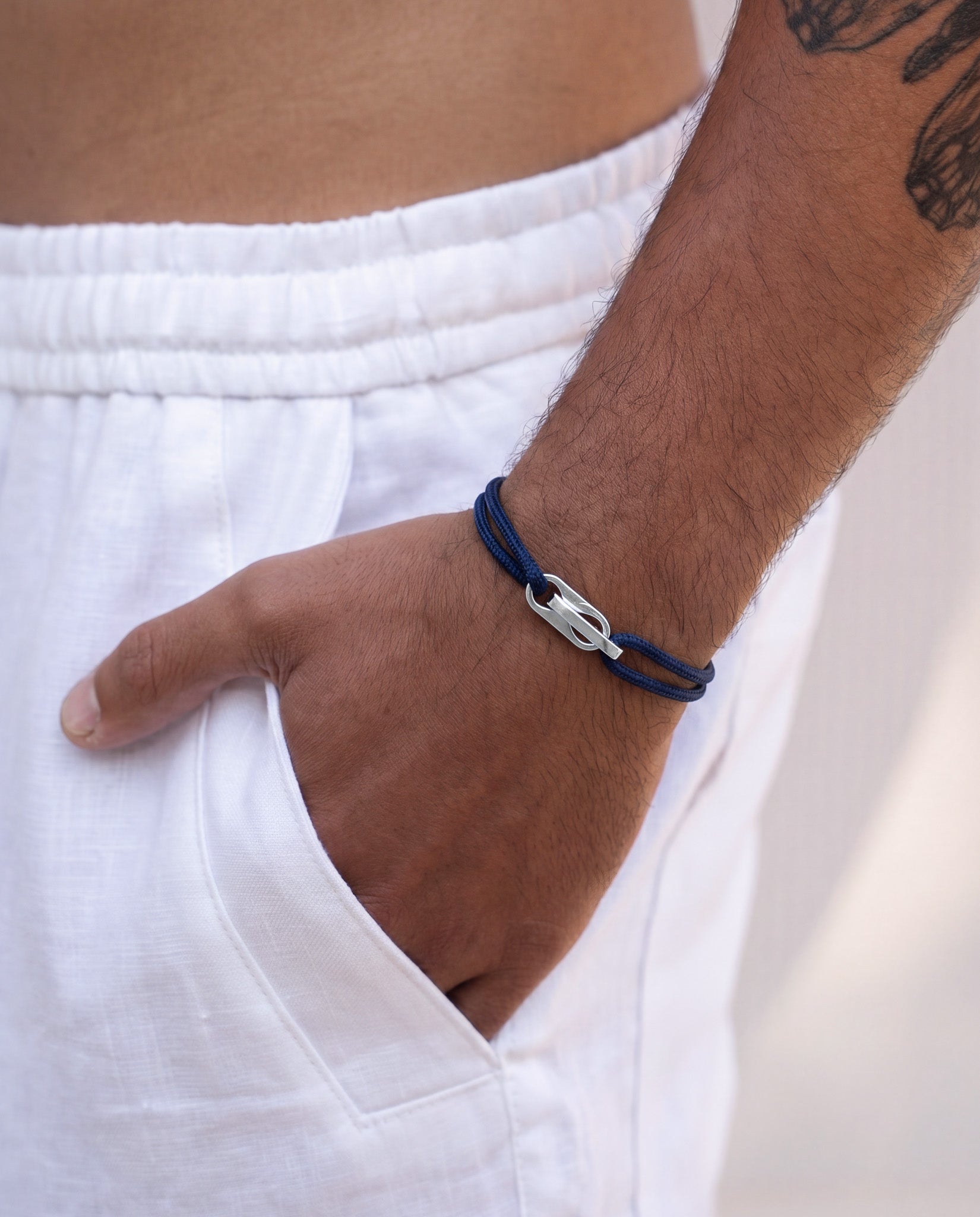 Atlantis bracelet featuring blue beads along a gold chain with a clasp