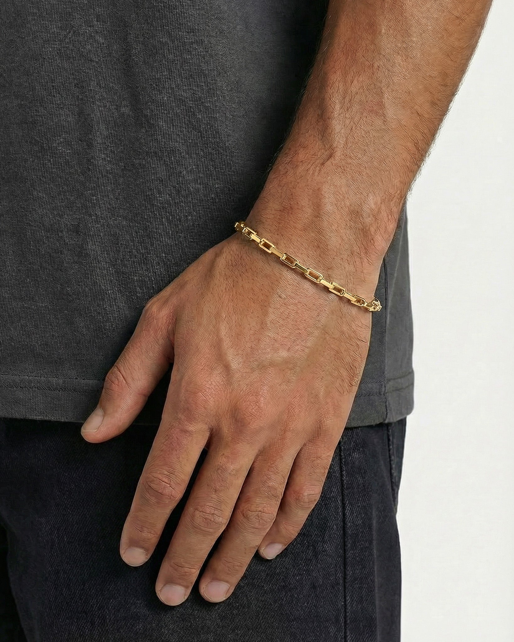 Capri Gold bracelet worn on the wrist with flat rectangular links and an adjustable extension chain