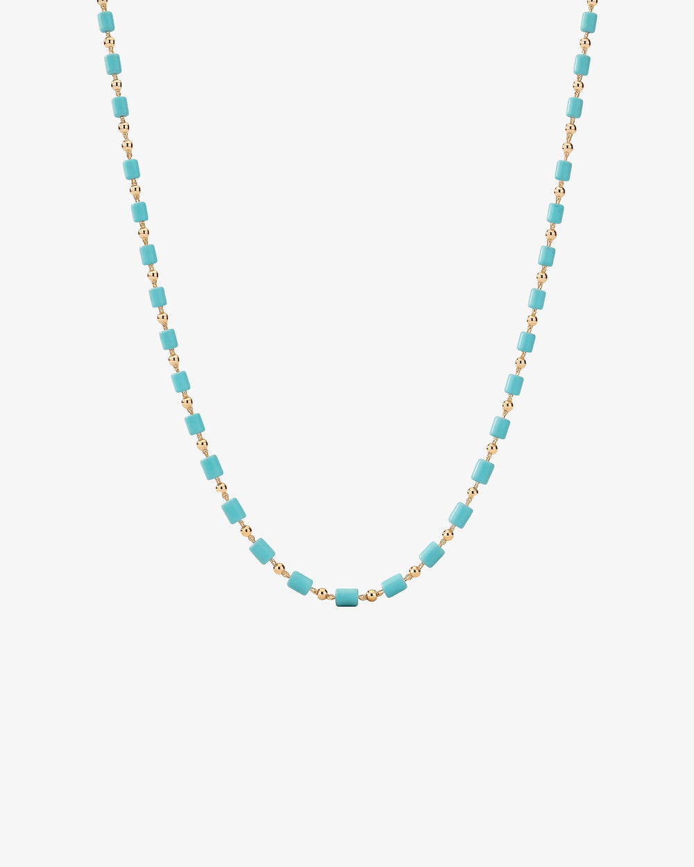 Turquoise cube bead necklace on a gold chain draped across a white background