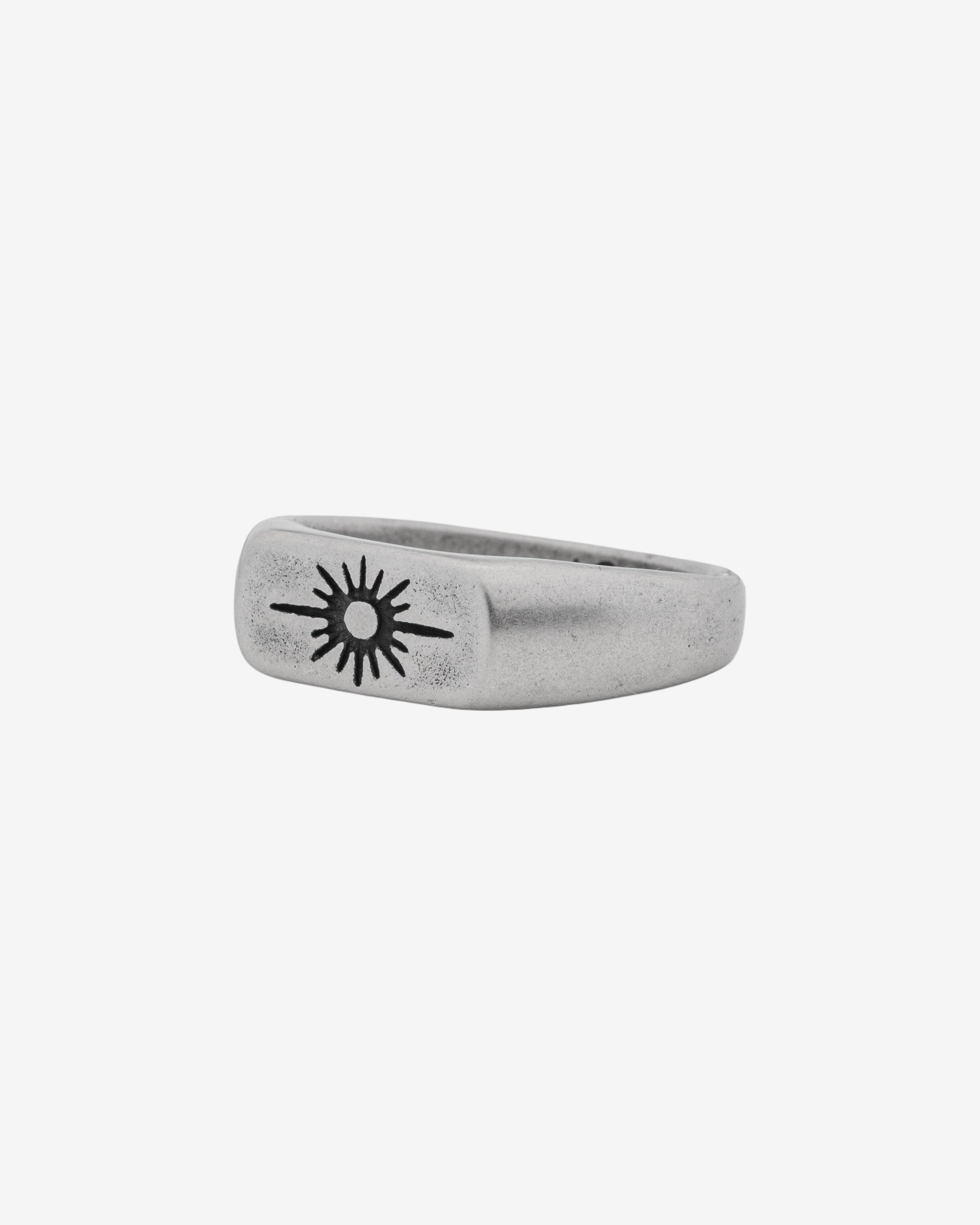 Horizon Silver Ring with sunburst emblem on finger in a brushed silver finish