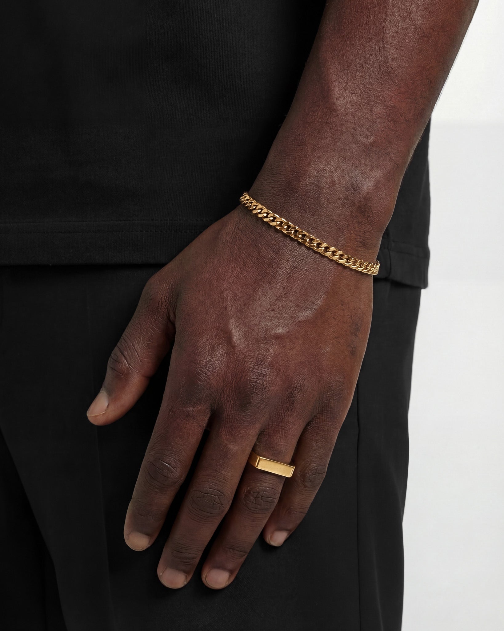 MILO Gold Ring with a flat rectangular top worn on a finger.