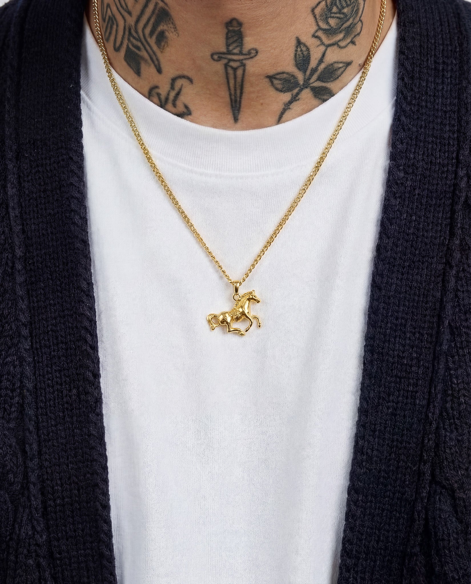Monaco Gold Necklace worn by a model over a white tee, horse pendant visible at chest.
