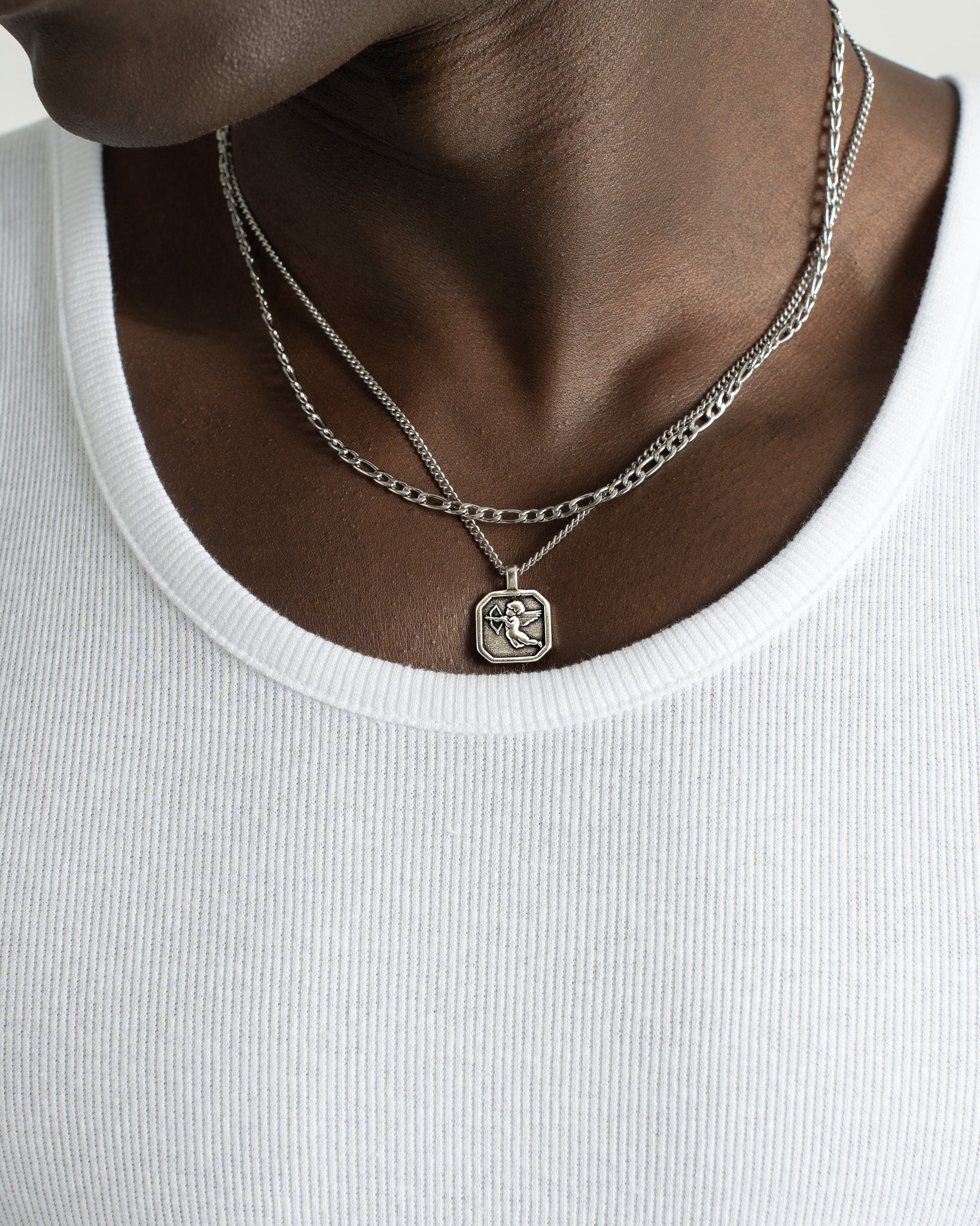 Two layer Amalfi Silver Chain around the neck with a small square pendant visible.