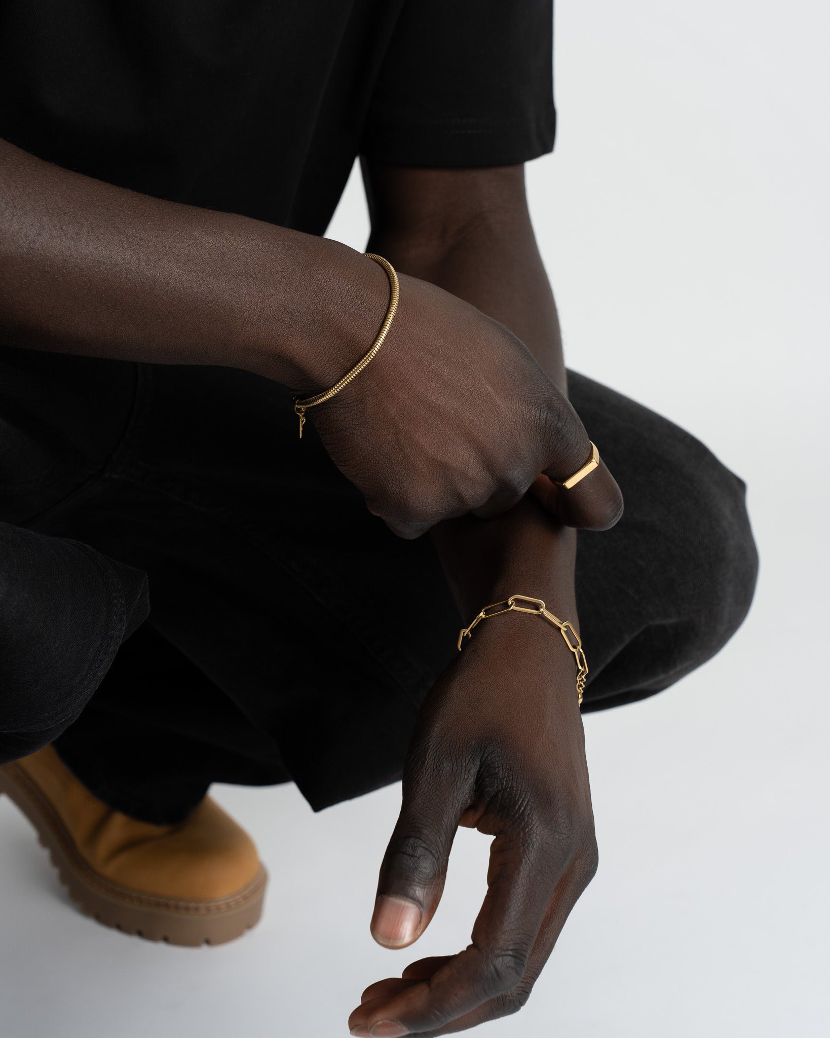 Model wearing Debod gold bracelet on the wrist showing the chain style and adjustable fit