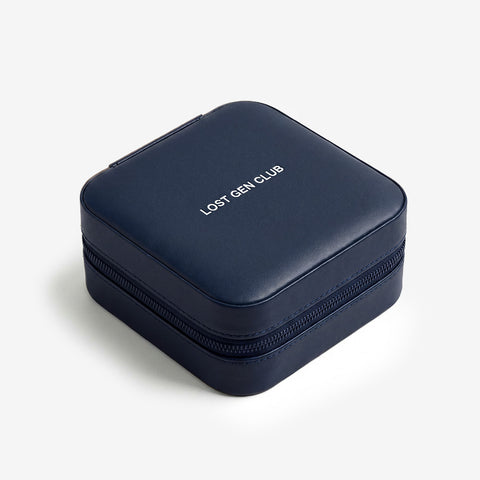 Dark blue travel box with a zip closure and LOST GEN CLUB on the lid