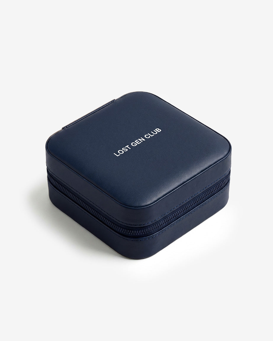 Dark blue travel box with a zip closure and LOST GEN CLUB on the lid