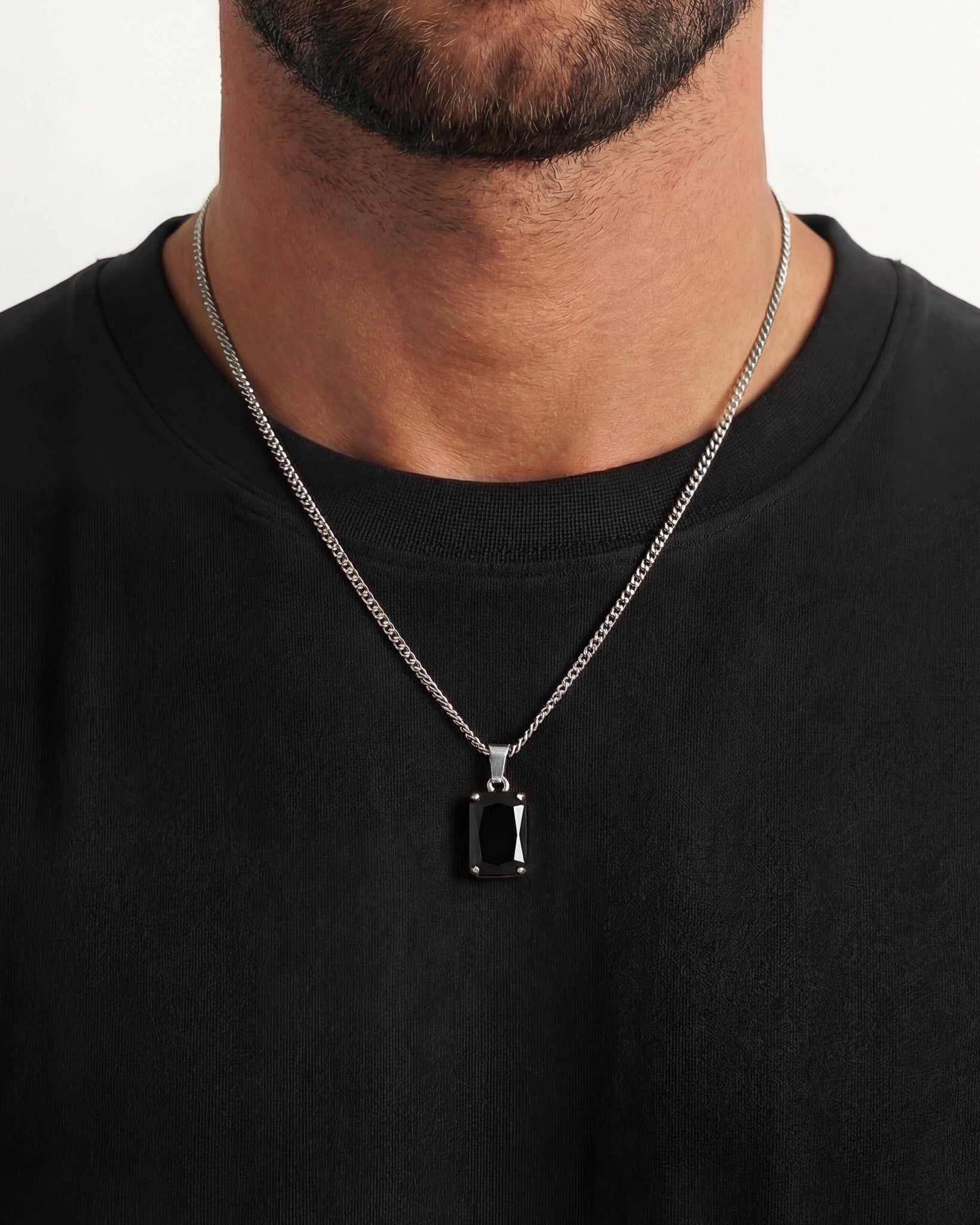 Man wearing a VOLT Silver necklace featuring a bold black rectangular pendant on a silver chain